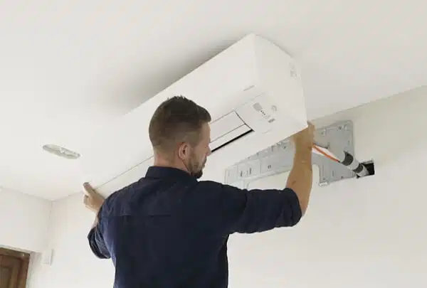 Engineer installing an air conditioning unit